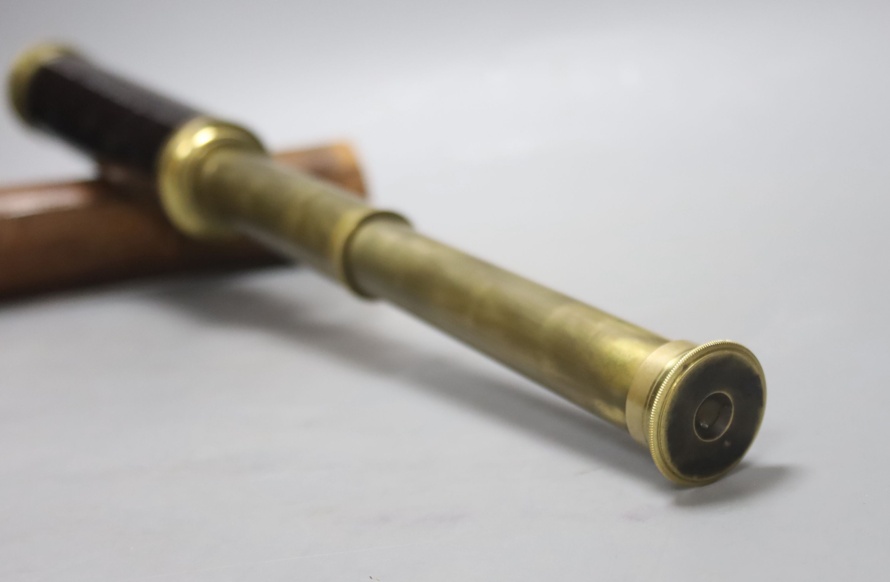 An early 20th century three drawer telescope by Lennie, Edinburgh, in leather case, and a cased slide rule